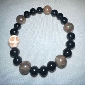 Crystal and glass beaded bracelet with carved skull